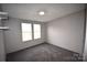 Bedroom with two windows and grey carpet at 4223 Old Catawba Rd, Claremont, NC 28610