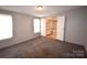 Primary bedroom with carpet and bathroom access at 4223 Old Catawba Rd, Claremont, NC 28610