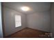 Simple bedroom with brown carpet and a window with blinds at 4223 Old Catawba Rd, Claremont, NC 28610