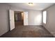 Simple bedroom with carpet flooring and double doors at 4223 Old Catawba Rd, Claremont, NC 28610