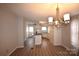 Open dining area with laminate flooring and chandelier at 4223 Old Catawba Rd, Claremont, NC 28610