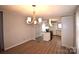 Bright dining room with chandelier and kitchen access at 4223 Old Catawba Rd, Claremont, NC 28610