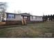 Front view of a ranch home with a brick base and deck at 4223 Old Catawba Rd, Claremont, NC 28610