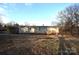 Rear view of the house showing deck and yard at 4223 Old Catawba Rd, Claremont, NC 28610