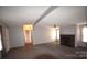 Spacious living room featuring a fireplace and carpet flooring at 4223 Old Catawba Rd, Claremont, NC 28610