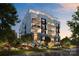 Luxury 3-story building with classic architecture, multiple balconies, and landscaped grounds at 409 Queens Rd # 203, Charlotte, NC 28207