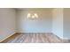 Inviting dining room featuring elegant chandelier lighting and wood flooring, creating a warm and inviting atmosphere for gatherings at 4223 S New Hope Rd # 8, Cramerton, NC 28032