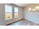 Bright and airy dining room with large windows providing ample natural light, complemented by a stylish chandelier and wood floors at 4223 S New Hope Rd # 8, Cramerton, NC 28032