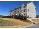 Landscaped townhomes feature neutral siding, multiple windows, and green spaces, creating an inviting community at 4223 S New Hope Rd # 8, Cramerton, NC 28032