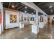 Spacious art gallery featuring diverse artwork, exposed brick, and polished concrete floors at 4223 S New Hope Rd # 8, Cramerton, NC 28032