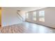 Spacious living area with hardwood floors, staircase, and large windows offering a bright and open atmosphere for relaxation and entertainment at 4223 S New Hope Rd # 8, Cramerton, NC 28032