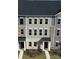 Three-story townhome featuring brick and gray siding, complete with black shutters and a covered entryway at 4225 S New Hope Rd # 9, Cramerton, NC 28032