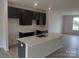 Modern kitchen with a spacious island, dark cabinets, and bright countertops at 4225 S New Hope Rd # 9, Cramerton, NC 28032