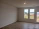 Bright living area with wood floors and two large windows overlooking the outdoors at 4225 S New Hope Rd # 9, Cramerton, NC 28032