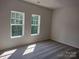 Bright bedroom featuring carpet, two windows letting in ample natural light, and neutral walls at 4229 S New Hope Rd # 11, Cramerton, NC 28032