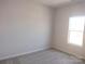 Neutral bedroom with one window letting in ample natural light, and neutral walls and carpet at 4229 S New Hope Rd # 11, Cramerton, NC 28032