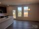 View of kitchen with island open to dining area and three rear windows at 4229 S New Hope Rd # 11, Cramerton, NC 28032