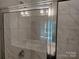 Modern bathroom shower with clear glass door and sleek fixtures complemented by elegant tiled walls at 4229 S New Hope Rd # 11, Cramerton, NC 28032