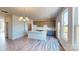 Open kitchen featuring an island with quartz countertop, modern gray cabinets, and a stylish chandelier at 4227 S New Hope Rd # 10, Cramerton, NC 28032