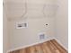 Efficient laundry room setup with hookups and shelving, maximizing space and convenience at 4227 S New Hope Rd # 10, Cramerton, NC 28032