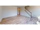 Open-concept living room with wood-look flooring, staircase, and neutral paint, creating a versatile space at 4227 S New Hope Rd # 10, Cramerton, NC 28032