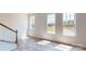 Bright living space with wood-look floors, large windows, and a wood staircase leading to the next level at 4227 S New Hope Rd # 10, Cramerton, NC 28032
