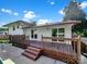 Inviting back deck with wood railings, sliding glass doors, and stairs leading to a concrete patio, perfect for outdoor entertaining at 1006 Wilson Blvd, Dallas, NC 28034