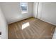 Bedroom featuring neutral carpet, white walls, and natural light from a window and a closet at 1006 Wilson Blvd, Dallas, NC 28034