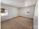 Bright bedroom with neutral carpet and natural light from two large windows at 1006 Wilson Blvd, Dallas, NC 28034