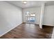 Bright dining area featuring wood floors, modern lighting, and glass doors leading to an outdoor pool and deck at 1006 Wilson Blvd, Dallas, NC 28034