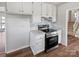 Kitchen with stainless steel appliances, white cabinets, and a view to the stairs at 1006 Wilson Blvd, Dallas, NC 28034