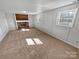 Open living room with brick fireplace, neutral carpet, and natural light at 1006 Wilson Blvd, Dallas, NC 28034