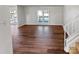 Open-concept living room features vinyl floors, natural light, and modern staircase at 1006 Wilson Blvd, Dallas, NC 28034