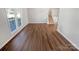 Spacious living room featuring vinyl floors, natural light, and modern staircase at 1006 Wilson Blvd, Dallas, NC 28034