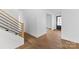 Light hardwood floors and staircase in an open entryway at 3038 Northampton Dr, Charlotte, NC 28210