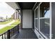 Cozy balcony with dark stained wood flooring, sleek metal railings, and views of the community at 413 Prine Pl # Brx0014, Charlotte, NC 28213