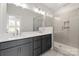 Modern bathroom featuring double sinks, a large mirror, and a glass-enclosed shower at 413 Prine Pl # Brx0014, Charlotte, NC 28213