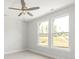 Bright bedroom with a ceiling fan and two large windows at 413 Prine Pl # Brx0014, Charlotte, NC 28213