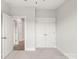 Bedroom featuring plush carpet and doors leading to additional spaces at 413 Prine Pl # Brx0014, Charlotte, NC 28213