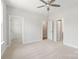 Spacious bedroom with neutral carpet and doors leading to the bathroom and closet at 413 Prine Pl # Brx0014, Charlotte, NC 28213