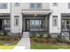 A covered front porch and front door entrance is the focal point of this townhome at 413 Prine Pl # Brx0014, Charlotte, NC 28213