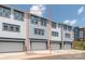 A gray townhome with a two-car garage, many windows, and modern curb appeal at 413 Prine Pl # Brx0014, Charlotte, NC 28213