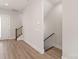 Bright hallway with wood-look flooring and staircase leading to upper and lower levels at 413 Prine Pl # Brx0014, Charlotte, NC 28213