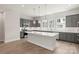 Bright kitchen featuring gray cabinets, stainless appliances, and a large center island with white counter at 413 Prine Pl # Brx0014, Charlotte, NC 28213