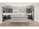 The spacious kitchen is designed with grey cabinets, stainless appliances and a large island at 413 Prine Pl # Brx0014, Charlotte, NC 28213