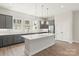 Modern kitchen features gray cabinets, a large island with white countertop, and stainless steel appliances at 413 Prine Pl # Brx0014, Charlotte, NC 28213
