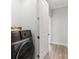 Modern laundry room featuring a gray washer and wooden-style floors at 413 Prine Pl # Brx0014, Charlotte, NC 28213