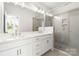A bathroom with double sinks, marble countertops, and a large glass shower at 417 Prine Pl # Brx0013, Charlotte, NC 28213