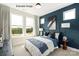 A contemporary bedroom with blue accent wall and soft natural light at 417 Prine Pl # Brx0013, Charlotte, NC 28213