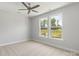 A stylish bedroom with wood paneling, natural light and elegant decor at 417 Prine Pl # Brx0013, Charlotte, NC 28213